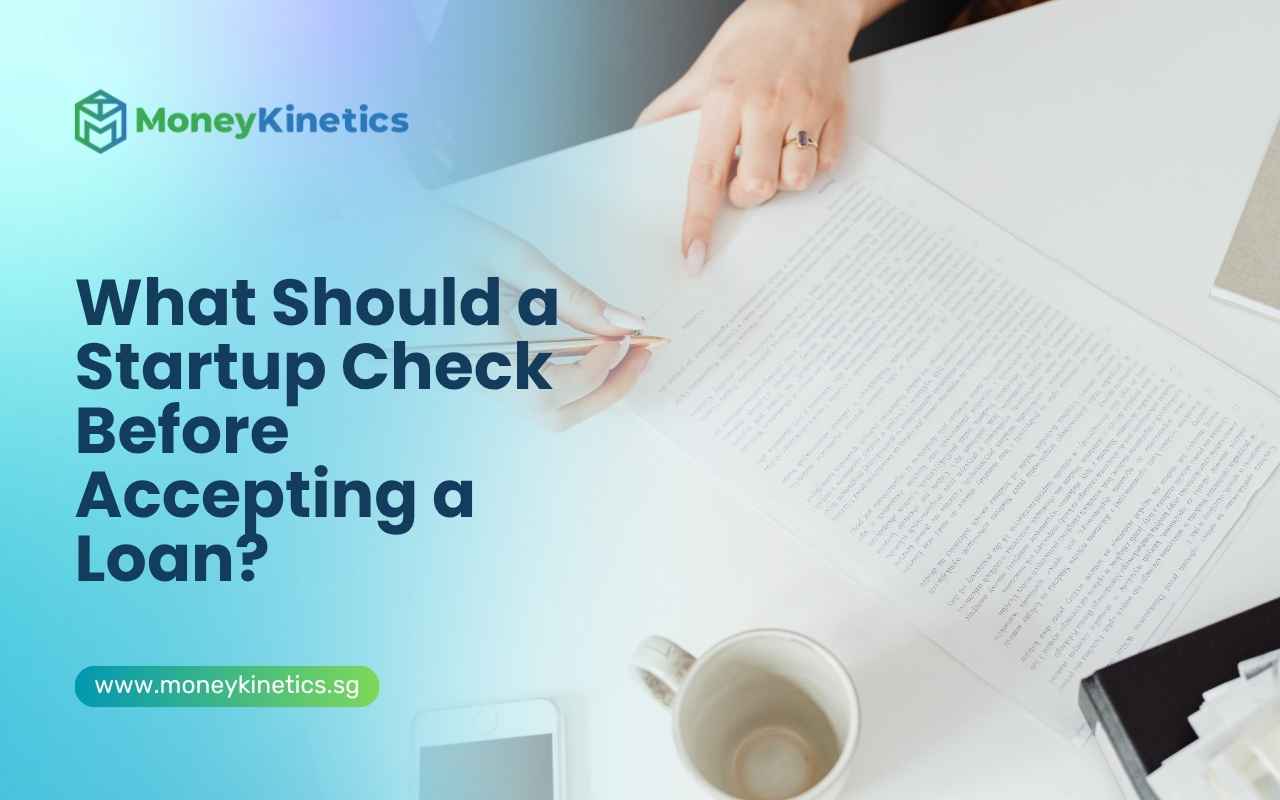 Business owner reviewing a loan agreement before accepting startup financing.
